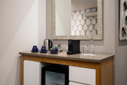 a room with a counter with a coffee maker on it at Protea Hotel by Marriott Cape Town Sea Point in Cape Town