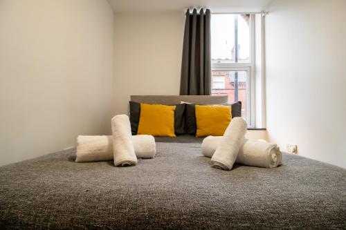 a bedroom with a bed with pillows and a window at Cosy and Homey 1br flat in Sunderland Centre - Flat 2 in Sunderland