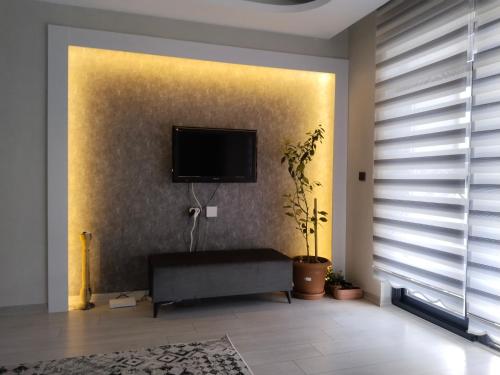 a living room with a flat screen tv on a wall at Ankara Esenboğa Airport Luxury Apart Concept in Ankara