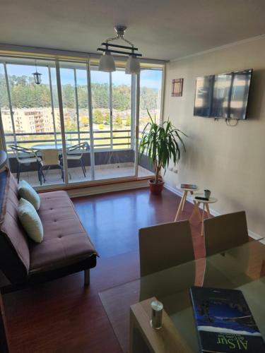 a living room with a couch and a table at Departamento San Pedro de la Paz in San Pedro de la Paz