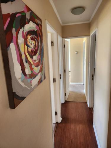 a hallway with a painting hanging on a wall at Departamento San Pedro de la Paz in San Pedro de la Paz