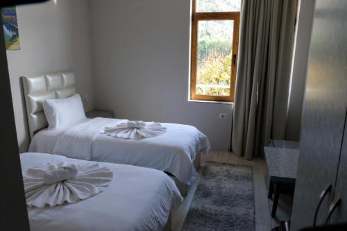 Una cama o camas en una habitación de Buna Park Hotel
