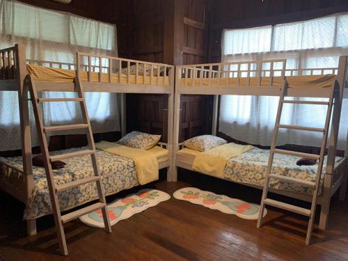 a couple of bunk beds in a room at Yor Song Hostel in Pai