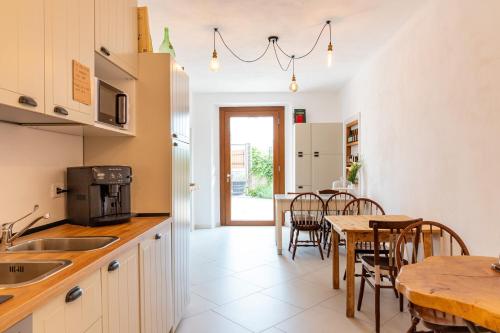 a kitchen and dining room with a table and chairs at Il Mallo Verde - Lake Como B&B in Mandello del Lario