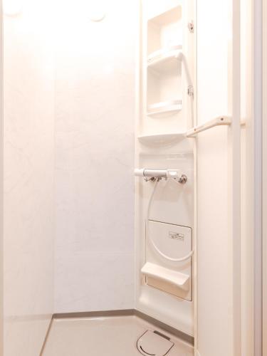 a white bathroom with a toilet in a room at Norichanchi in Nozawa Onsen