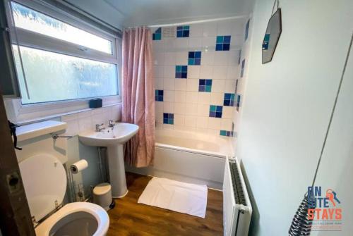 a bathroom with a toilet and a sink at OnSiteStays - Contractor Friendly Retreat, 2-BR Terrace House near A2 in Gravesend