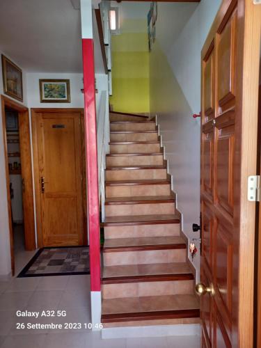 a staircase in a house with colorful walls and a door at Habitaciones Gioly in Puerto del Rosario