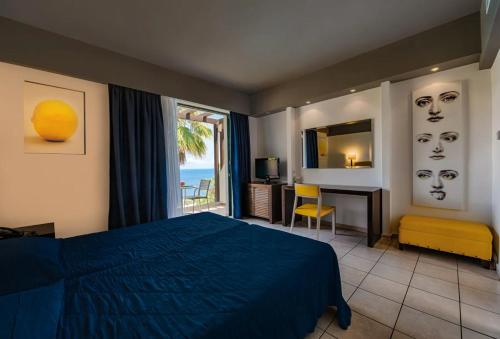 a bedroom with a bed and a view of the ocean at Apostolata Island Resort and Spa in Skala