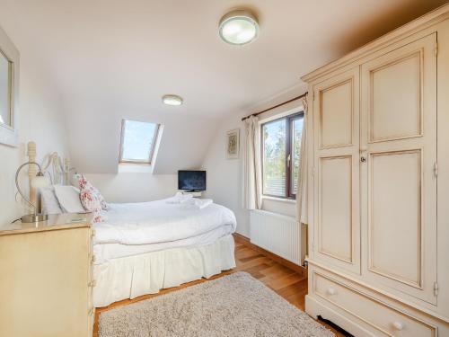 a white bedroom with a bed and a window at Barley Cottage- Uk45598 in Verwick