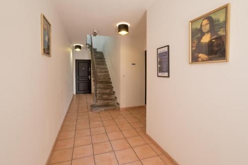a hallway with a staircase in a house at Baignoire Centre Ville Narbonne in Narbonne