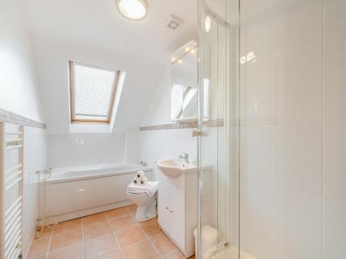 a bathroom with a toilet and a sink and a shower at Barley Cottage- Uk45598 in Verwick