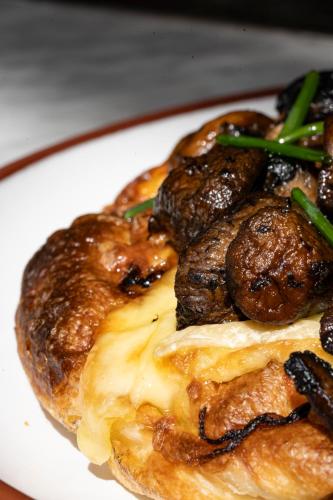 a plate of food with meat and green onions at Four Seasons Hotel Buenos Aires in Buenos Aires