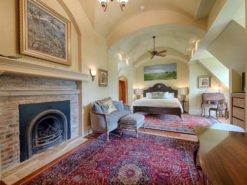 een slaapkamer met een bed en een open haard bij Adams Hill House Retreat - Artist-Architect's Estate, Newfane Vermont in Newfane