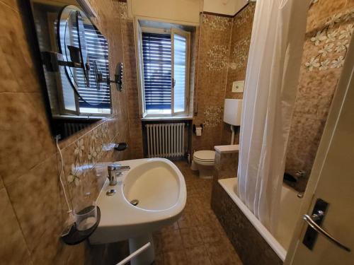 a bathroom with a sink and a toilet and a window at Locazione Turistica San Vigo in Vigasio