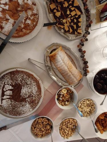 a table topped with different types of pies and desserts at Hotel Vigo in Vigo di Fassa