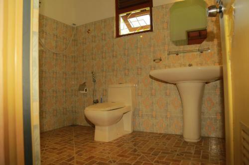 a bathroom with a toilet and a sink at 31 sea view in Tangalle