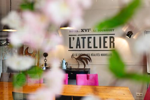 a table with pink chairs and a sign that reads ladder at Hotel De L'Atelier in Villeneuve-lès-Avignon