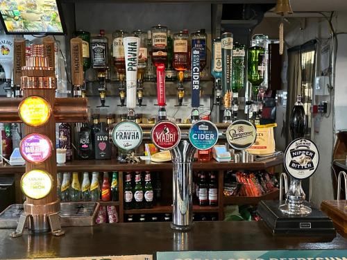 a bar with lots of signs on the wall at Waverley Inn in Newport