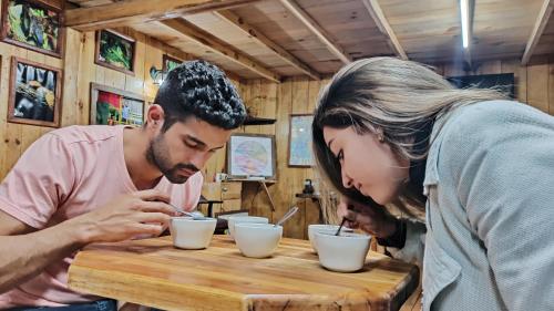 a man and a woman sitting at a table eating food at TREE TREK BOQUETE Adventure Park in Boquete