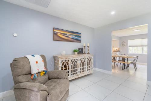 a living room with a chair and a table at Beautiful Home in Naples with Huge Private Pool in Naples