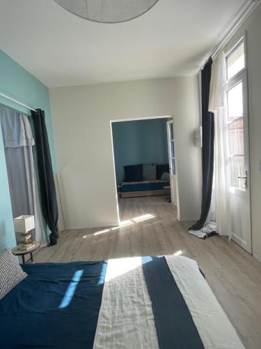 a bedroom with a bed and a flat screen tv at La possibilité d'une île in Boyardville