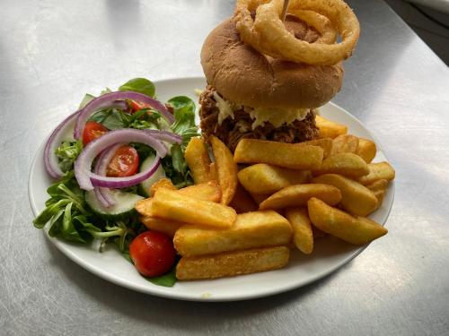 a plate of food with a sandwich and french fries at Waverley Inn in Newport