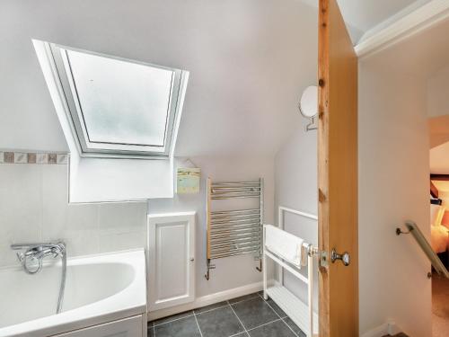 a bathroom with a window and a tub and a sink at Beacon - Uk44719 in Ravenscar