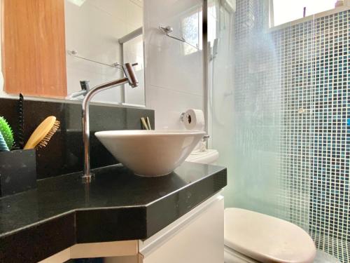 a bathroom with a bowl sink on a counter at Portal do Jaragua in Belo Horizonte