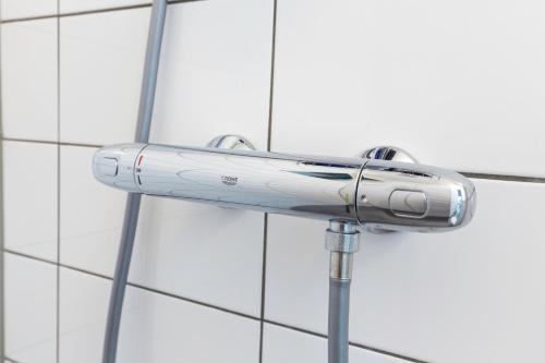 a shower head on the side of a wall at Family executive Studio with Balcony open Delft Utopia Flora 20F in Delft