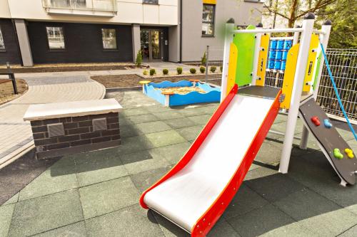 a playground with a slide and a play equipment at Apartament MAJA Giżycko Żeglarska in Giżycko