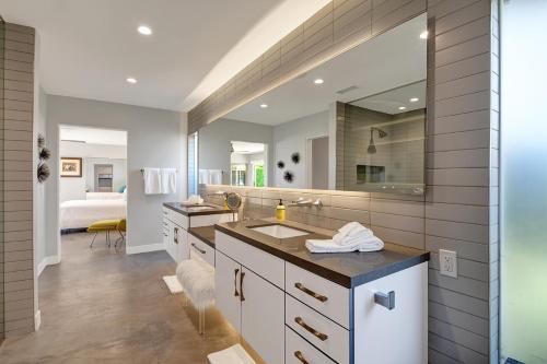 a bathroom with a sink and a mirror at Ultra-Luxury- Resort Style Private Compound-Close to Everything- 3BD/2.5BA in Palm Springs