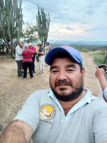 a man wearing a hat standing on a dirt road at Hostal Makesa Tatacoa in Villavieja
