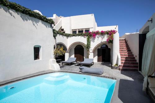 a swimming pool in the yard of a house at Ducato Wine Village in Megalochori