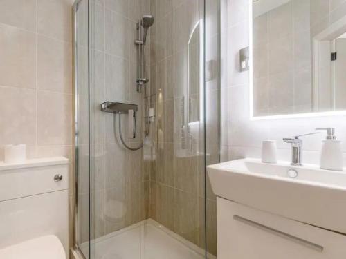 a bathroom with a glass shower and a sink at Pass the Keys The Eaves Style & Sophistication Central Bakewell in Bakewell