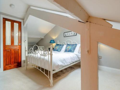 a bedroom with a white bed in a attic at Pass the Keys The Eaves Style & Sophistication Central Bakewell in Bakewell