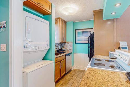 a kitchen with a refrigerator and a washer and dryer at Wight Bay North #439 in Ocean City