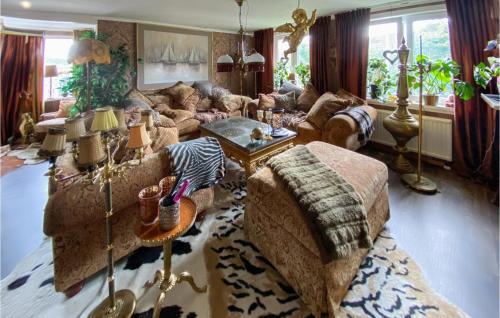 a living room with a couch and a table at Nice Home In Grimmered With House A Panoramic View 
