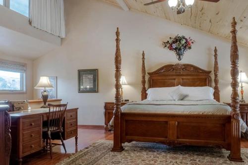ein Schlafzimmer mit einem Holzbett mit Schreibtisch und Kommode in der Unterkunft 10 min to Ski | Views | Golf Course | AC + Hot Tub in Durango