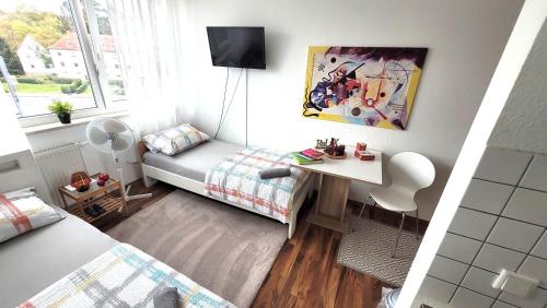 a small room with a bed and a desk in it at Appartement Bahnhof in Mainz