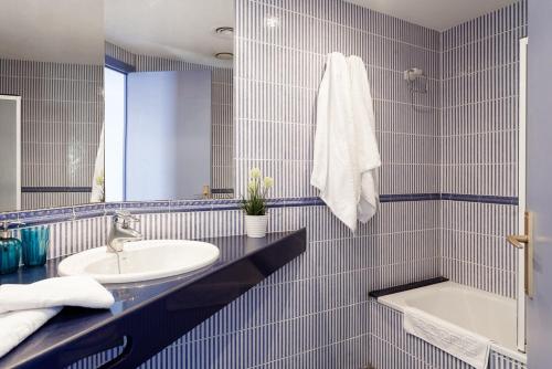 a bathroom with a sink and a mirror at El Trull Apartaments in Lloret de Mar