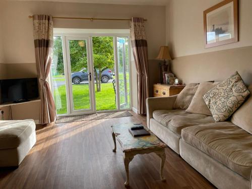 a living room with a couch and a table at Formby Point in Liverpool