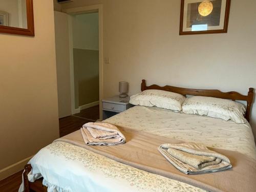 a bedroom with two beds with towels on them at Formby Point in Liverpool