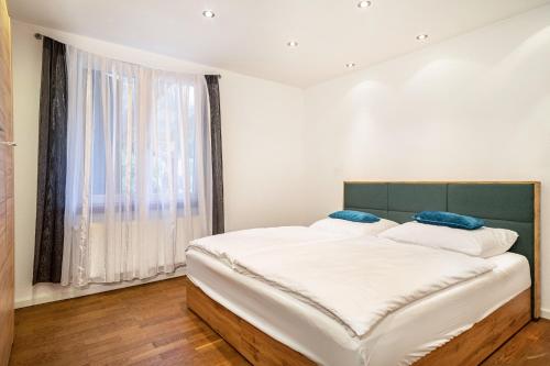 a bedroom with a large bed and a large window at Deine Traumwohnung in Bad Saulgau