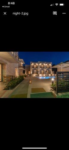 a screenshot of a house with a picture of it at Sofibel sivota suites in Sivota