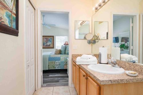 un bagno con lavandino e una camera con letto di Vacation King Bed Home w Pool & Game room, near Disney a Davenport