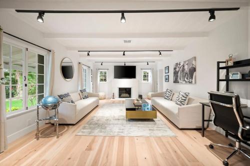 a living room with white furniture and a fireplace at Chic 3BR Oasis in Studio City:Toluca Lake Adjacent in Los Angeles