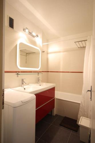 une salle de bain avec un lavabo blanc et un miroir dans l'établissement FLOCON Joséphine Immobilier, à La Salle Les Alpes