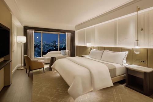 a hotel room with a large bed and a large window at The Westin Tokyo in Tokyo