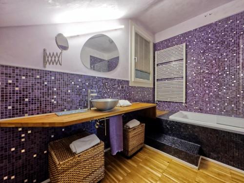 a bathroom with a sink and a bath tub at Arzignano Charm: Modern Home With Parking! in Arzignano