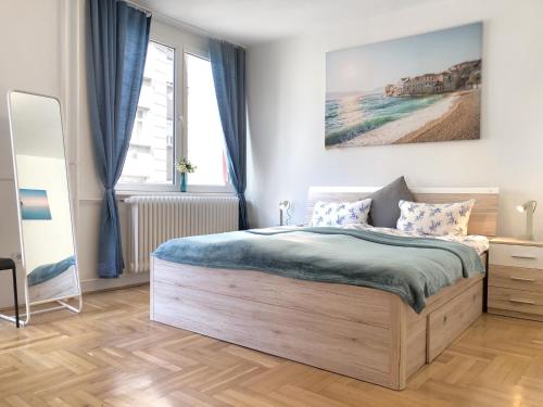 a bedroom with a bed and a large window at Castle Corner Apartment in Budapest